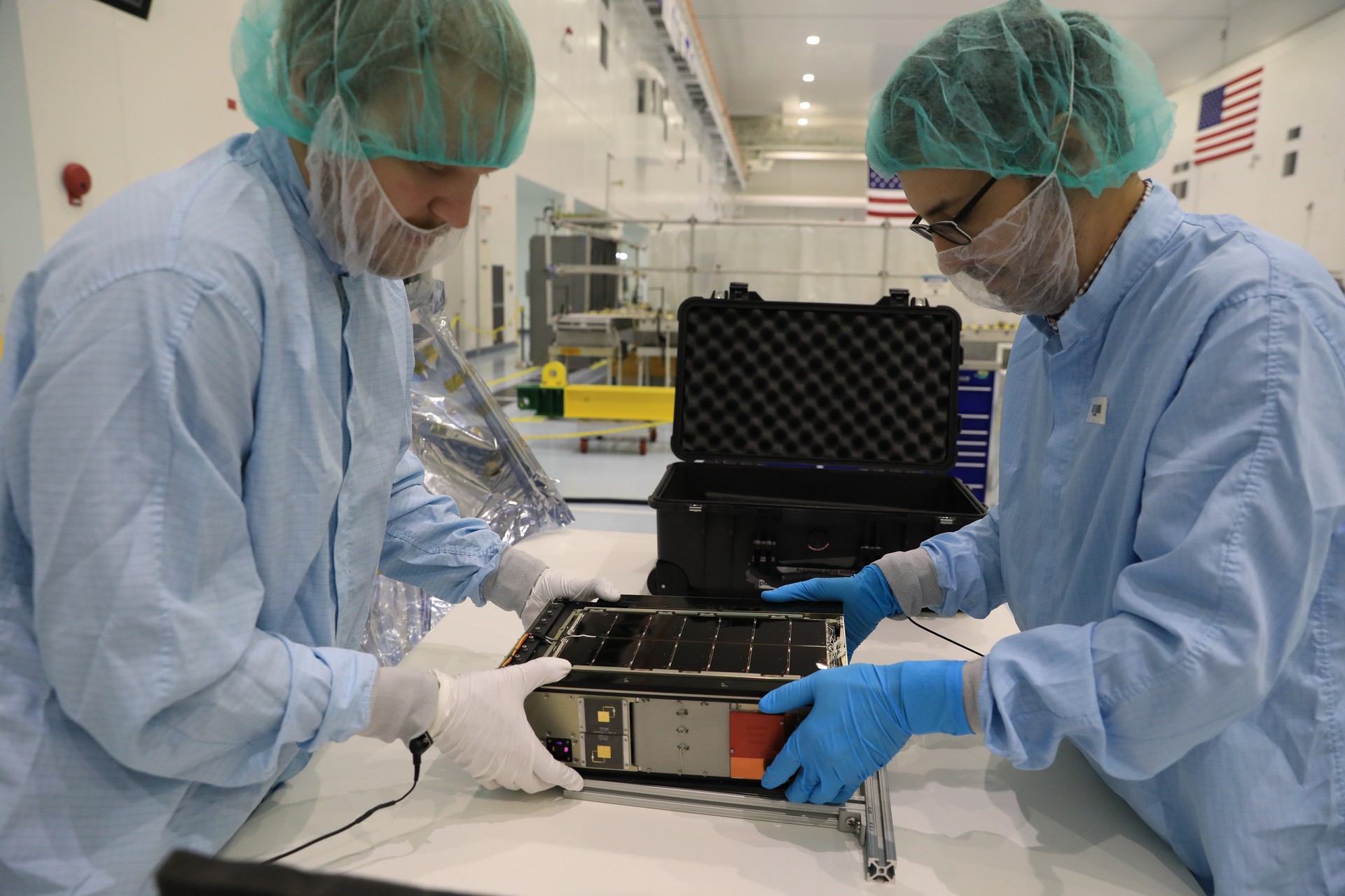 NASA engineers assembling the LunaH-Map CubeSat inside the Space Station Processing Facility at Kennedy Space Center, July 2021.