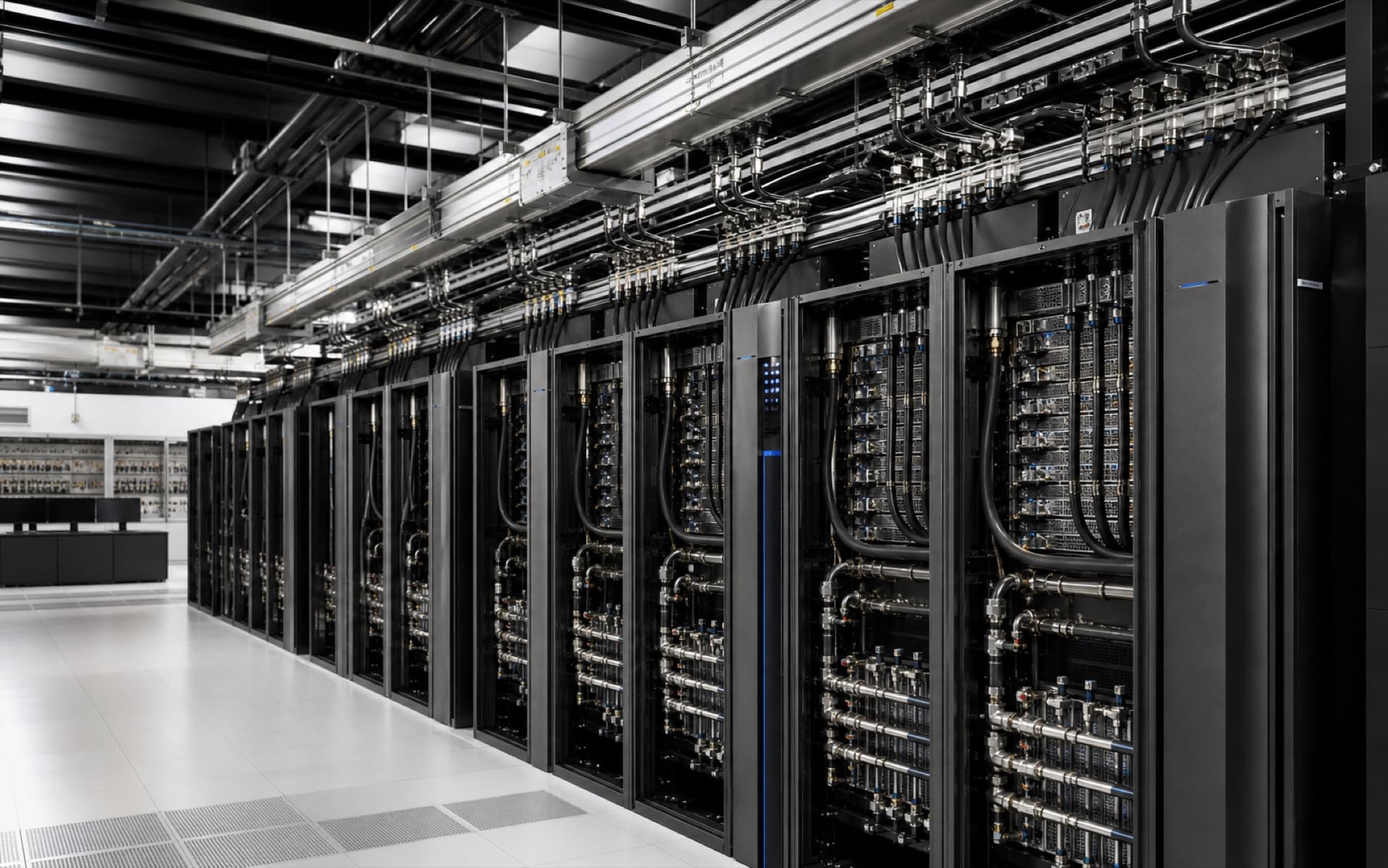 Inside an AI data centre row with liquid-cooled accelerator racks, overhead busway, fibre trunks, and a single blue status signal.