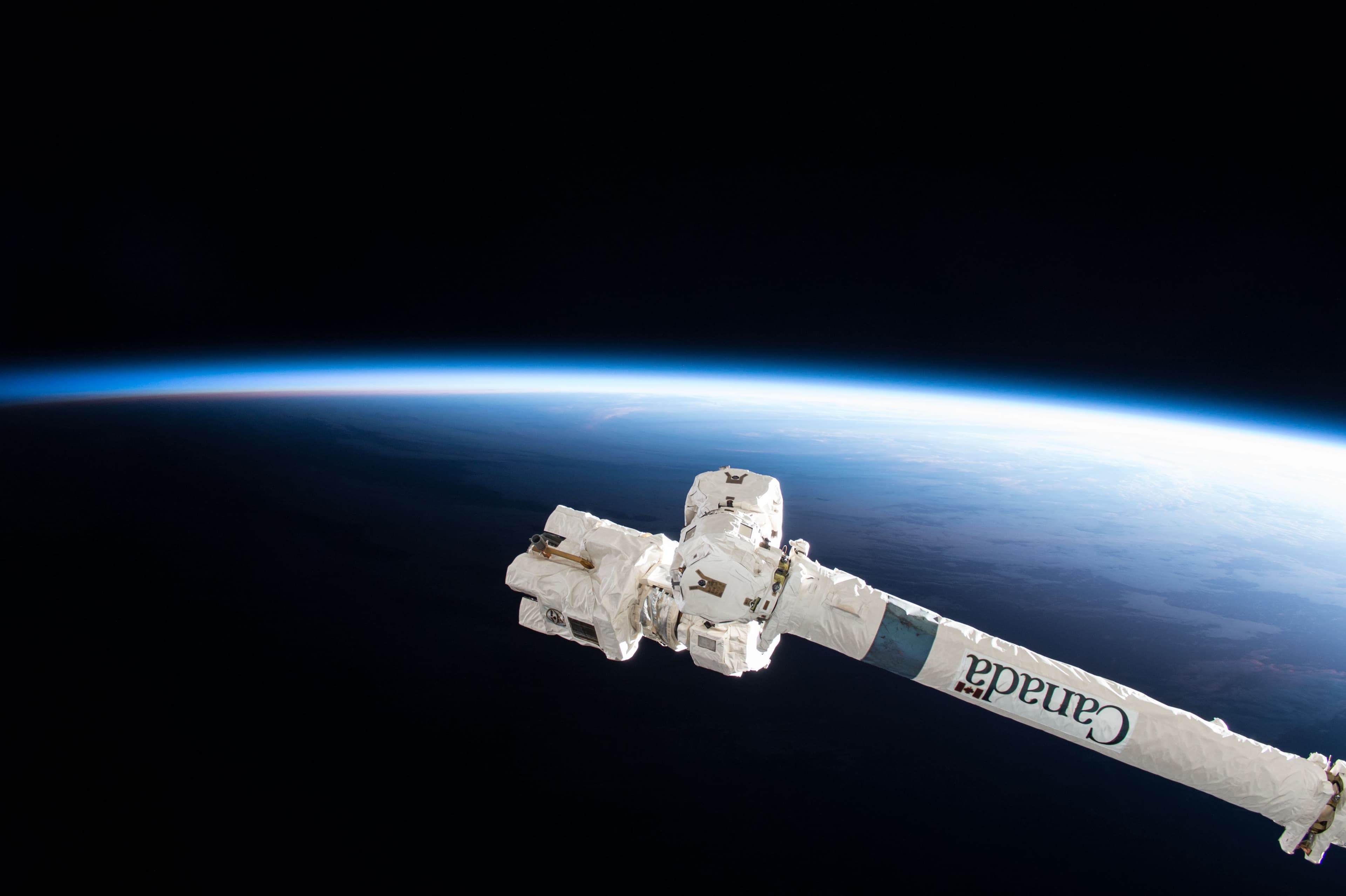 The Canadarm2 robotic manipulator above Earth in low orbit